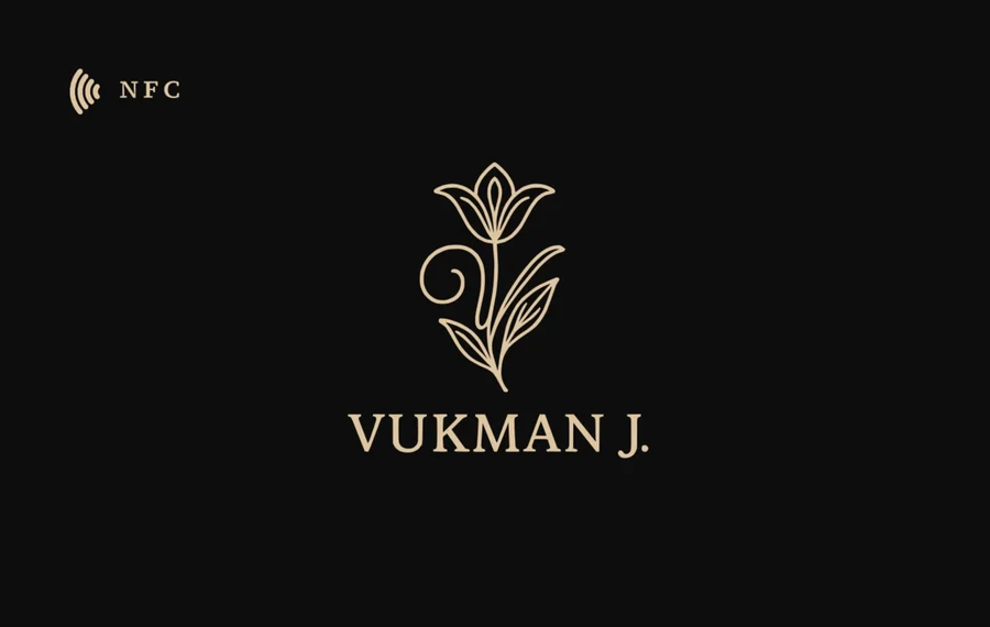 The Vukman J. card: a gold lily on black above the name, front